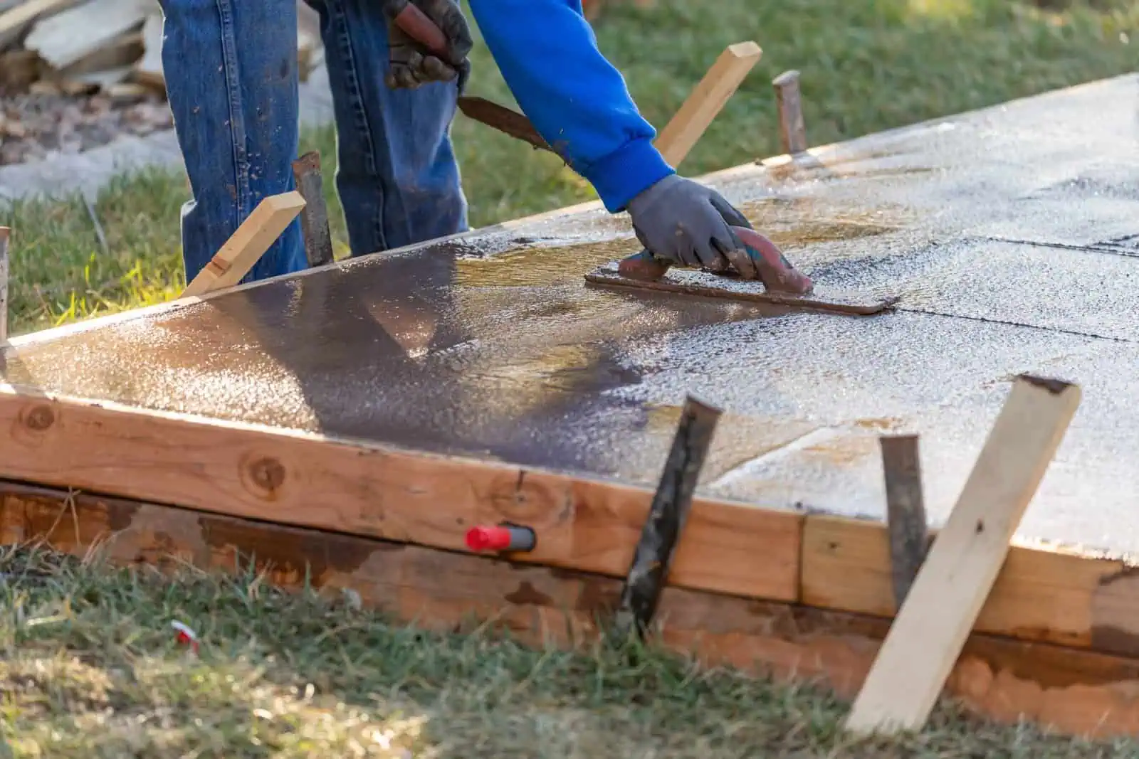 Construction Worker Smoothing Wet Cement With Trowel Tools